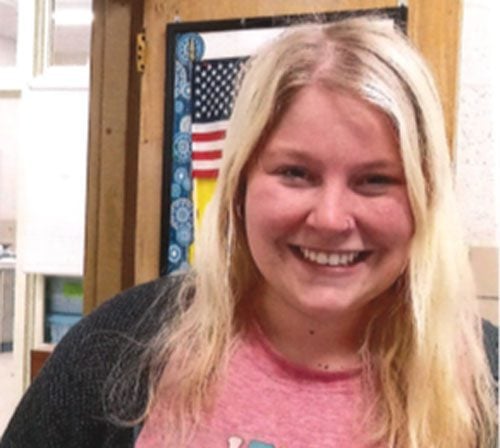 Smiling adult with blonde hair.